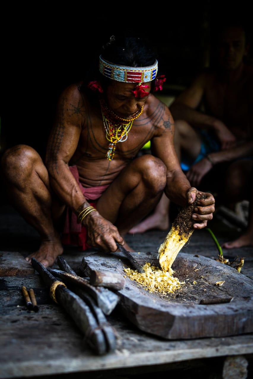 Intricate geometric tattoos across the body and chest of a Mentawai elder